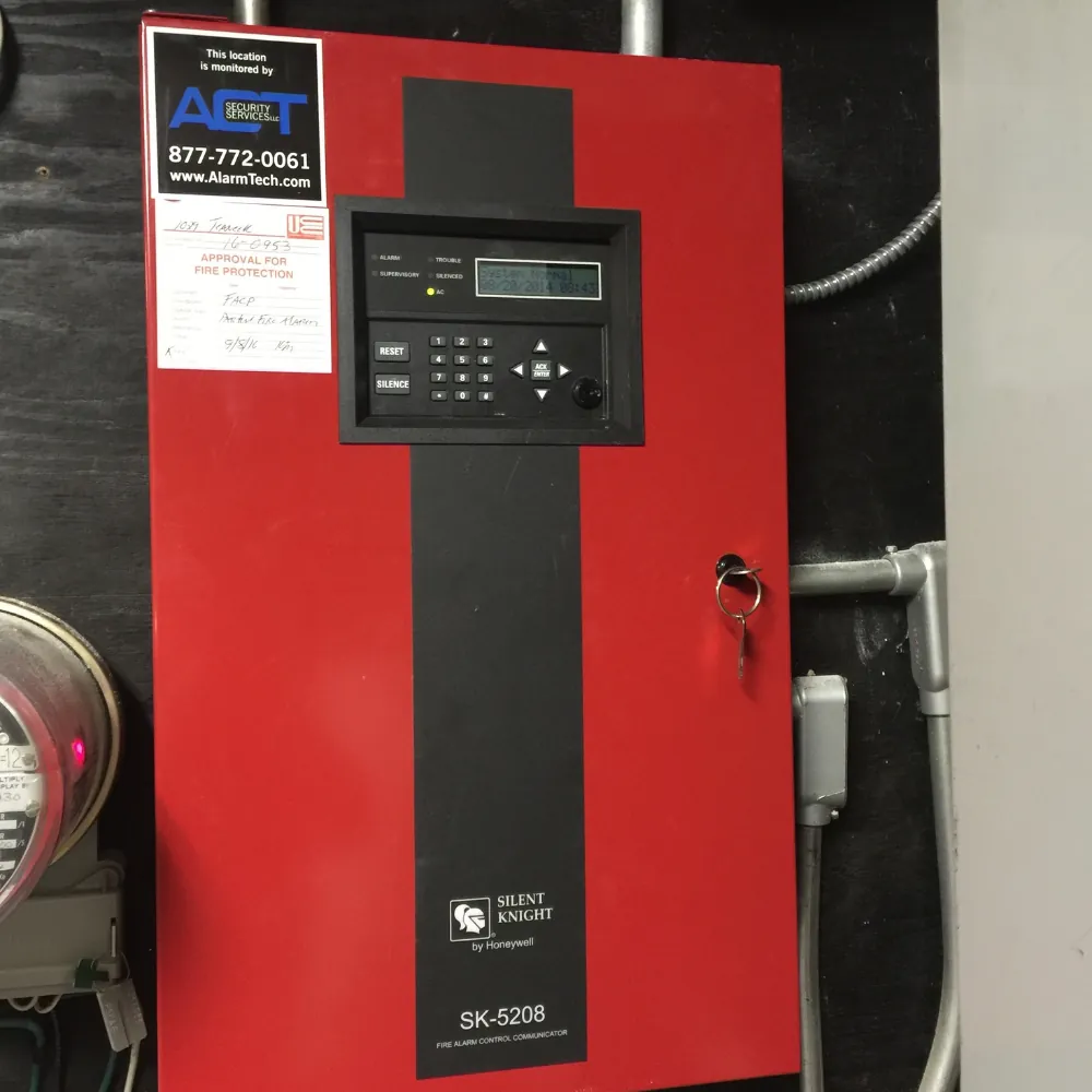 Cellular alarm communicator installed next to a fire panel